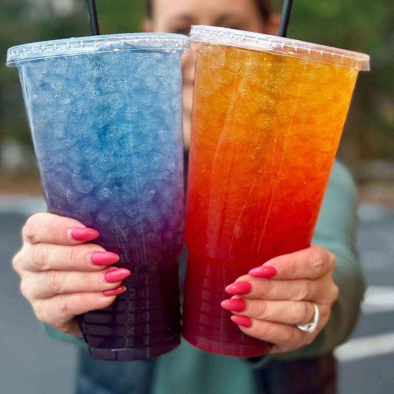 Two mega teas held side by side — one blue ombre, one sunrise orange